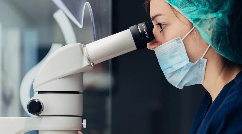 Woman looking in microscope